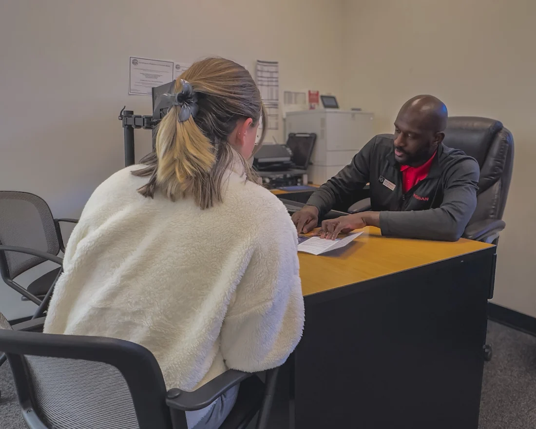 Finance team member reviewing payment options with a customer at Victorville Mitsubishi