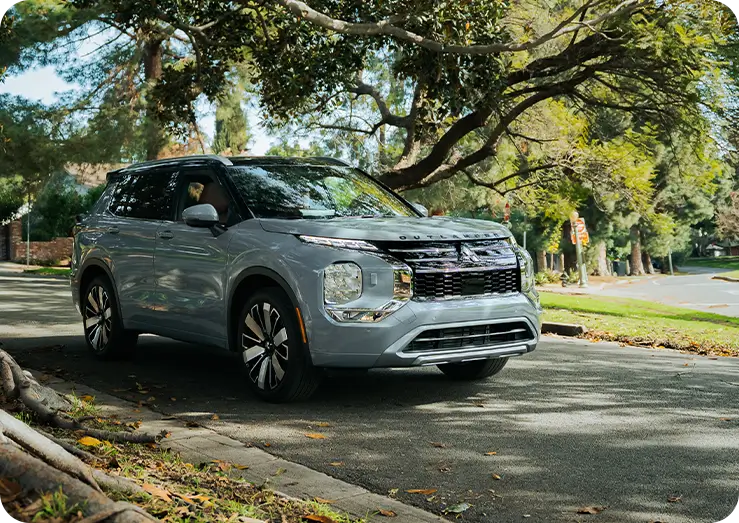 Mitsubishi Outlander driving through a neighborhood